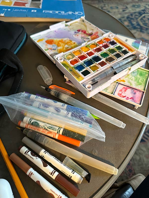 Photo of watercolors, markers, and other art supplies